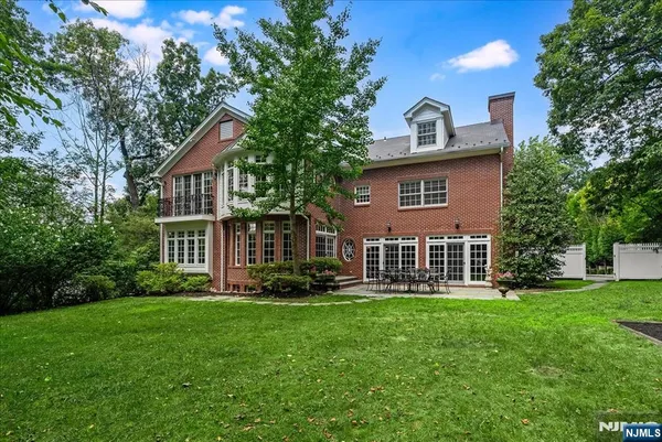a front view of a house with a yard and trees