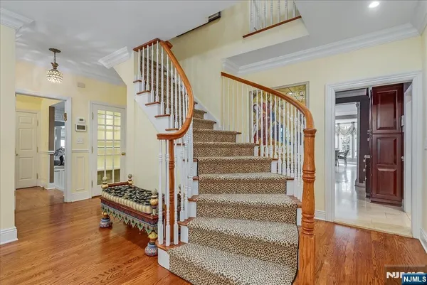 a view of entryway and hall with wooden floor