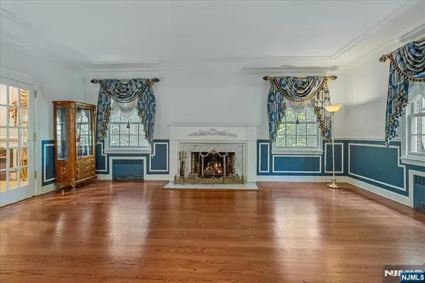 a view of an empty room with fireplace and a window