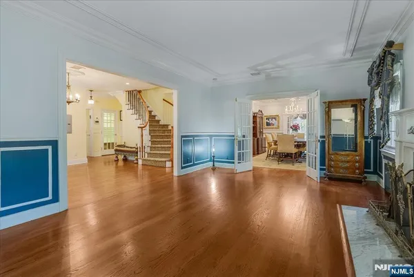 an empty room with wooden floor and a view