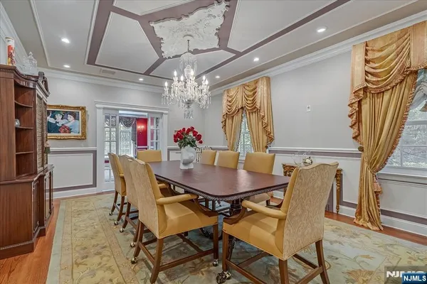 a view of a dining room with furniture and a chandelier
