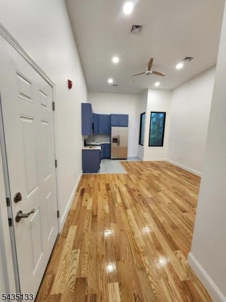 189 Main Street, Unit 3B Paterson, NJ 07505 - Photo 2 of 6 a spacious bedroom with a bed and a dresser