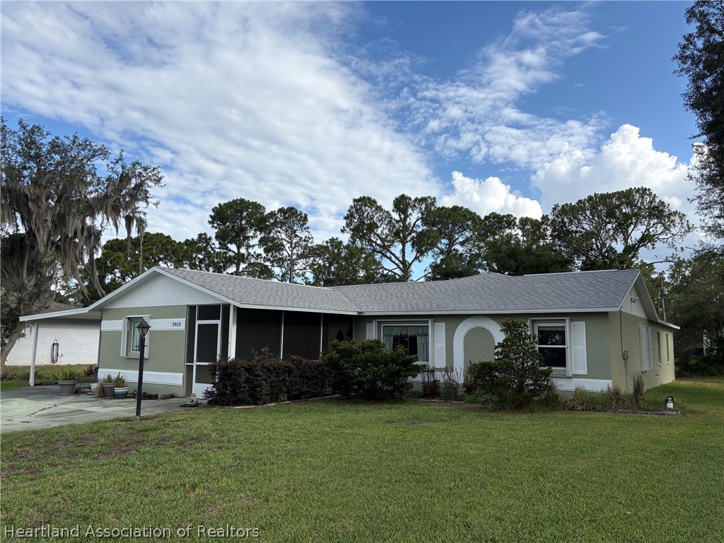 3913 Ferrari Drive Sebring, FL 33872 - Photo 1 of 20 a front view of a house with a garden