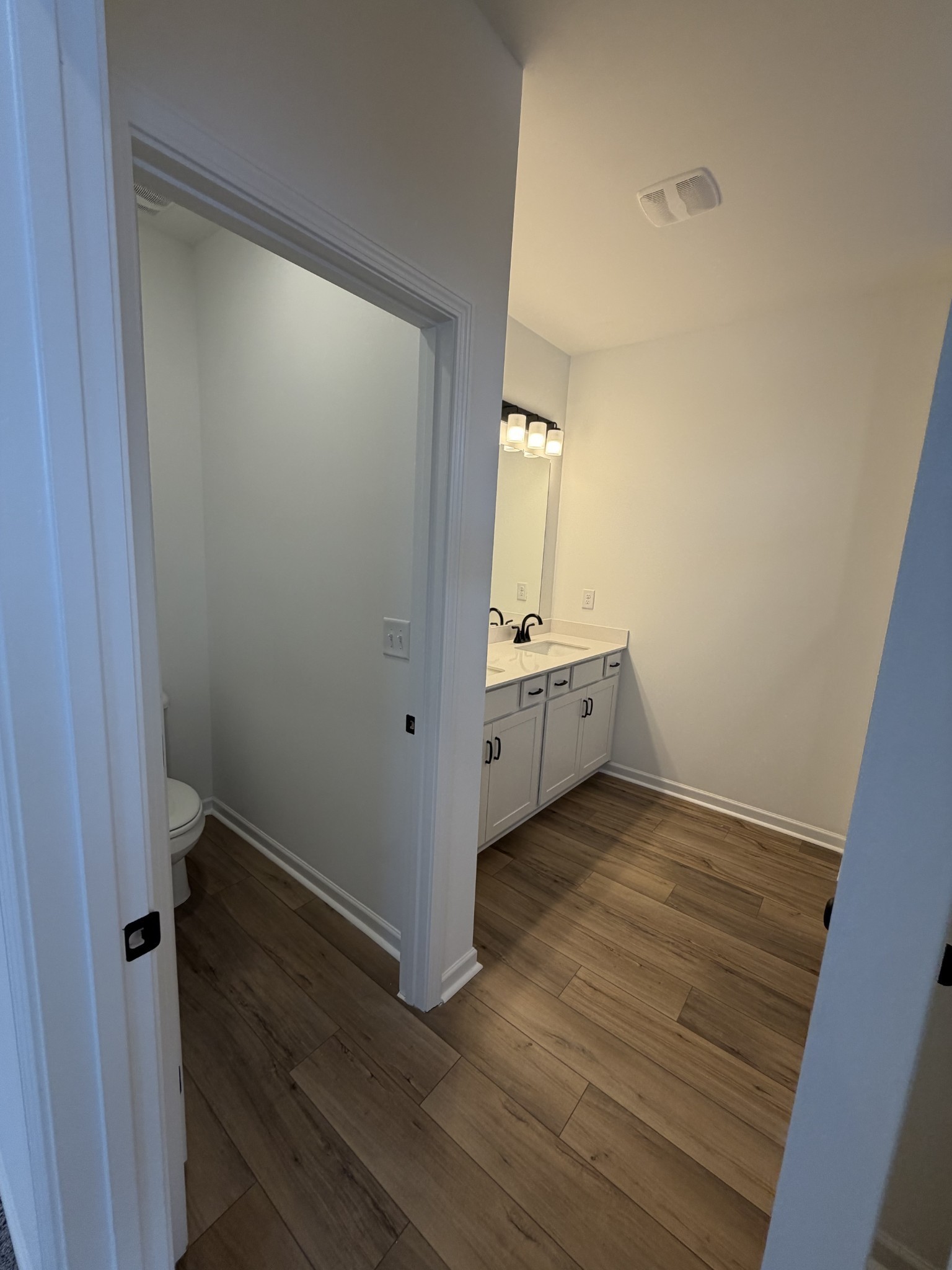 119 Yarrow Loop Clarksville, TN 37043 - Photo 13 of 25 an empty room with wooden floor and cabinet
