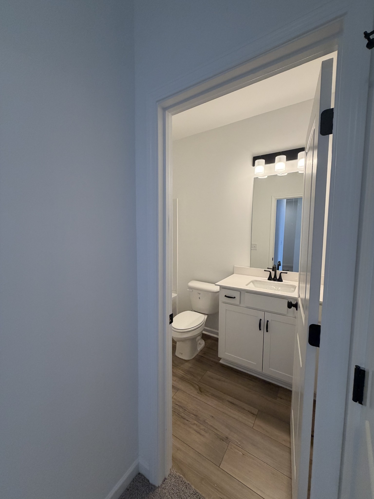 119 Yarrow Loop Clarksville, TN 37043 - Photo 24 of 25 a bathroom with a sink vanity and a toilet