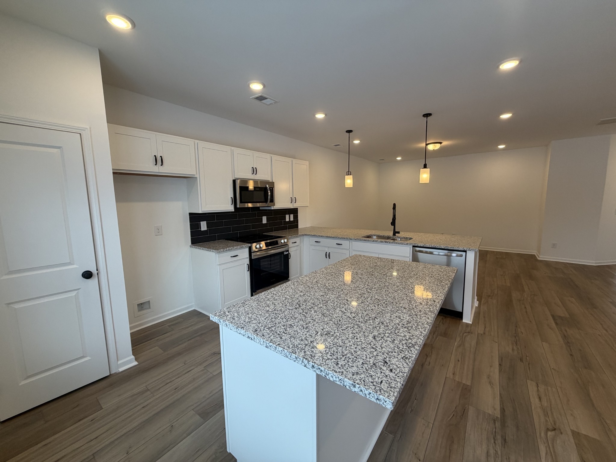 119 Yarrow Loop Clarksville, TN 37043 - Photo 6 of 25 a kitchen with kitchen island a counter top space appliances and cabinets