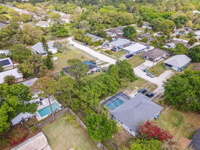an aerial view of residential houses with outdoor space