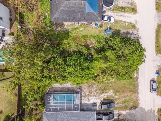 a view of backyard with plants and outdoor seating