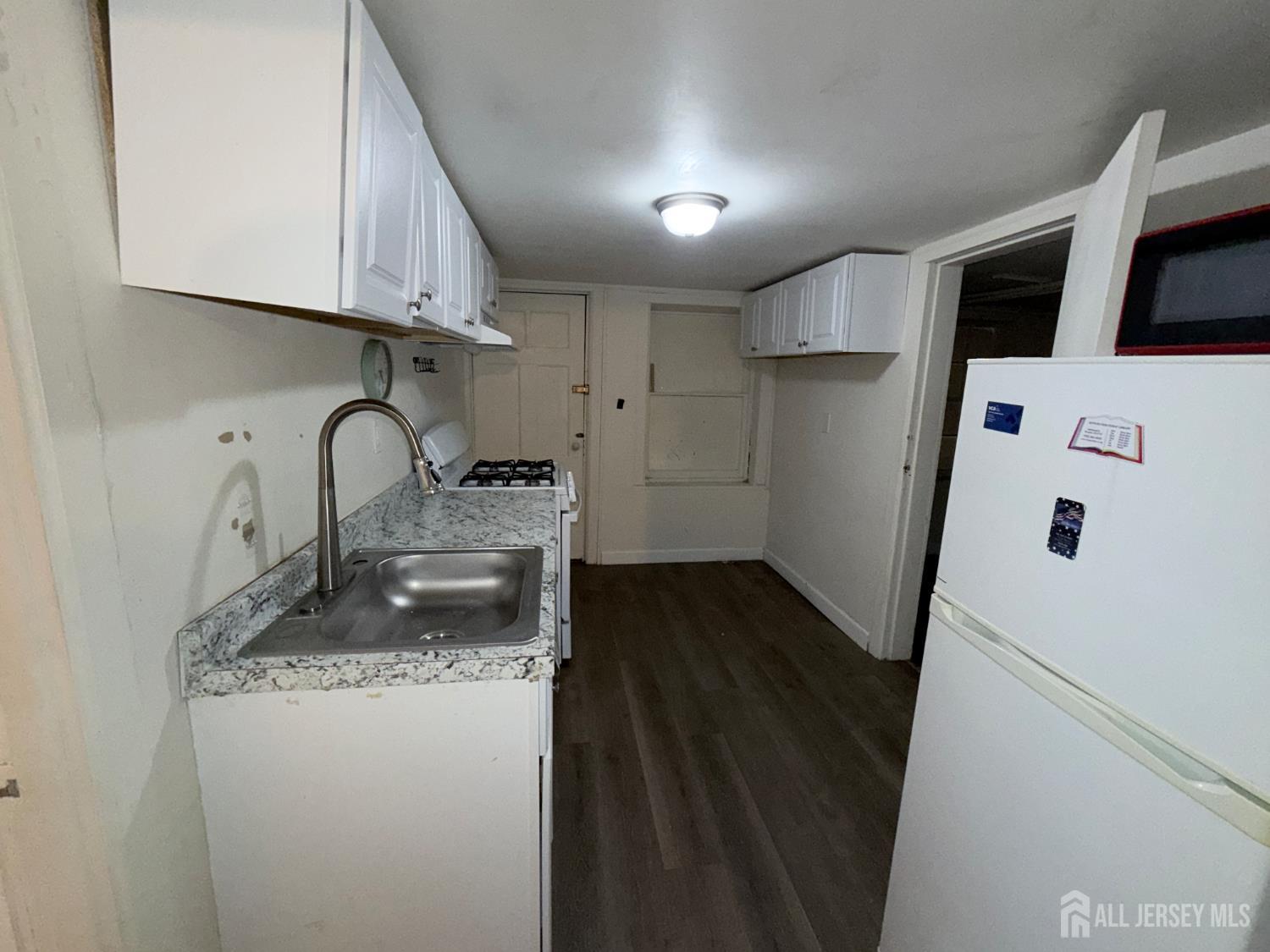 41 Atlantic Street Keyport, NJ 07735 - Photo 40 of 48 a kitchen with stainless steel appliances a sink a stove a refrigerator and cabinets