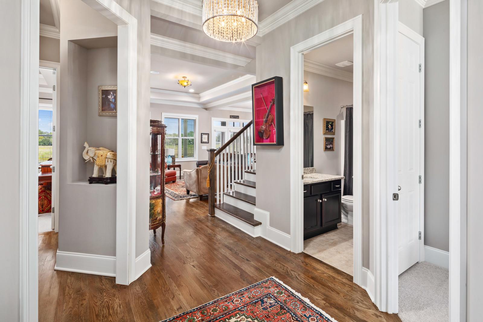 Upon entering the home, you will find the gleaming sand and finish hardwood floors and upgraded lighting.