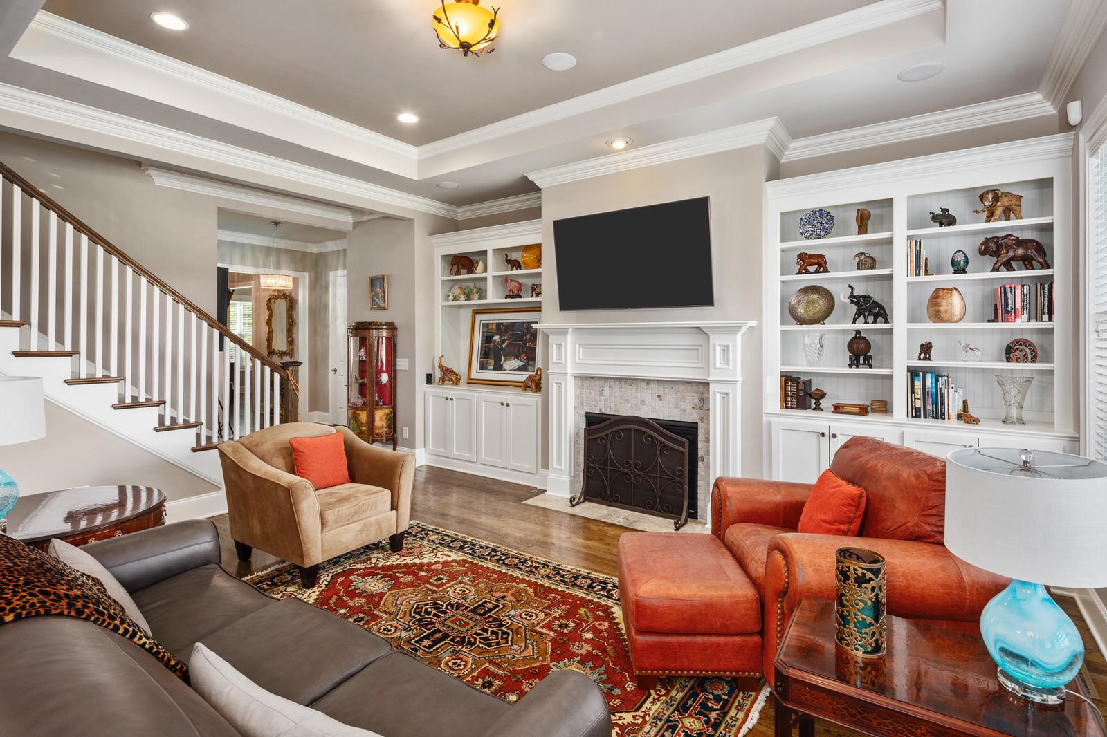Another view of the family room highlights the gas fireplace flanked by custom built ins.