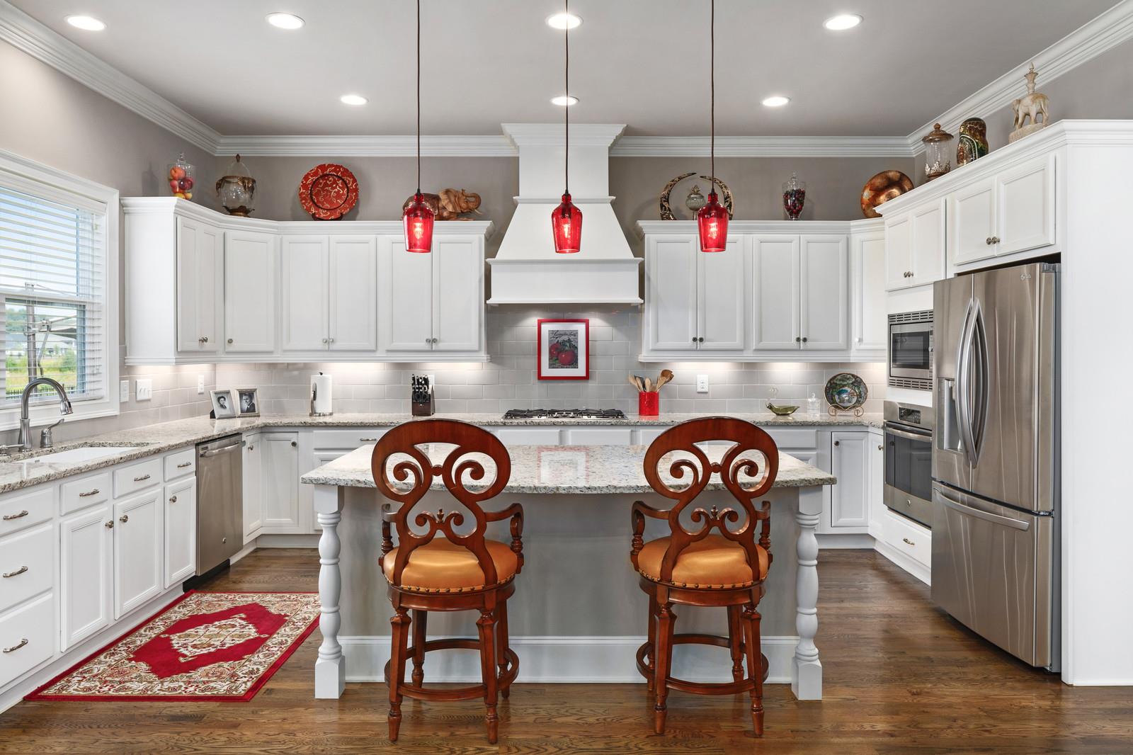 476 Avon River Road Franklin, TN 37064 - Photo 8 of 25 The chef's kitchen has an oversized island with granite counter tops, pendant lighting and bar seating.