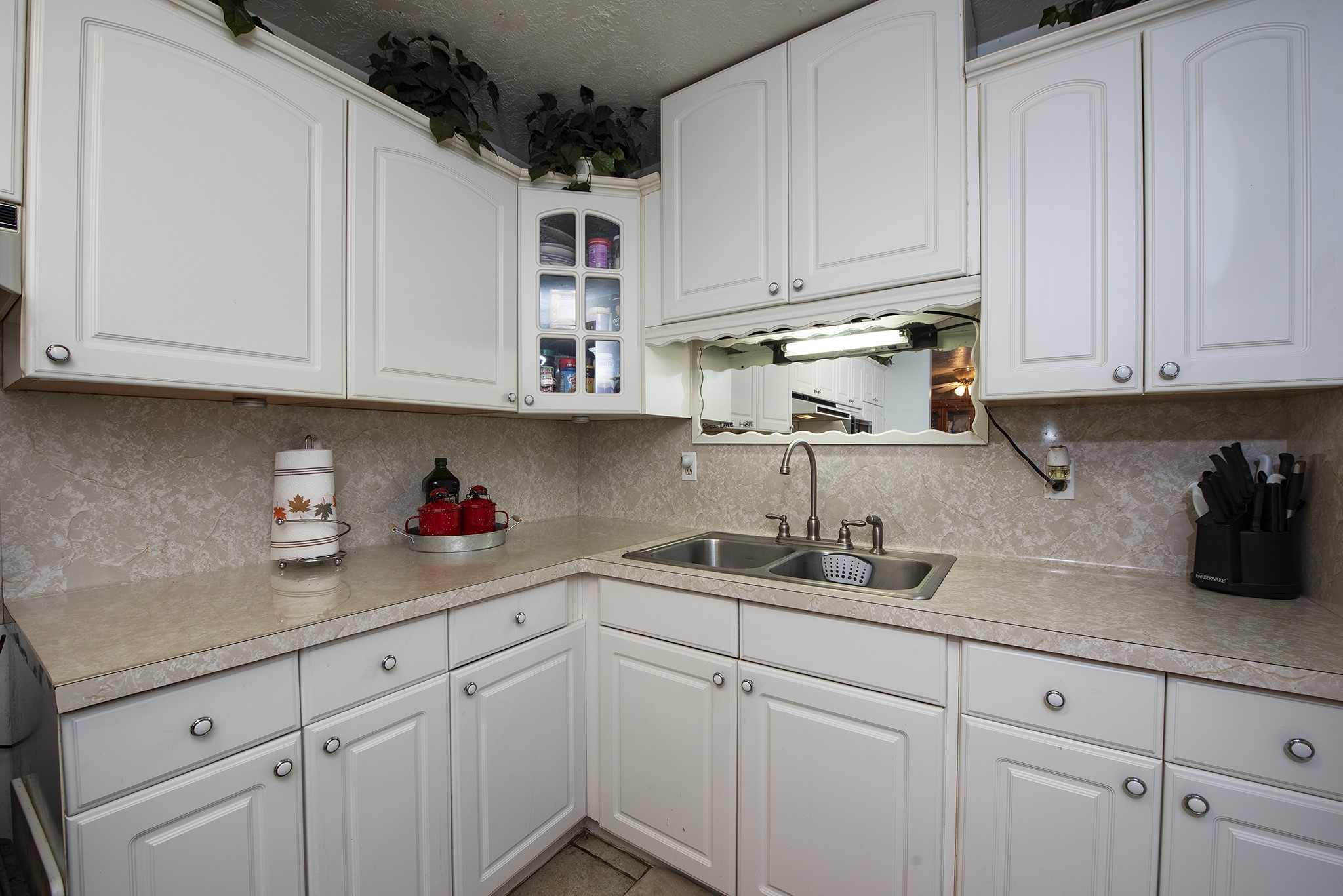 22234 Castle Road Waller, TX 77484 - Photo 24 of 50 a kitchen with white cabinets and a sink