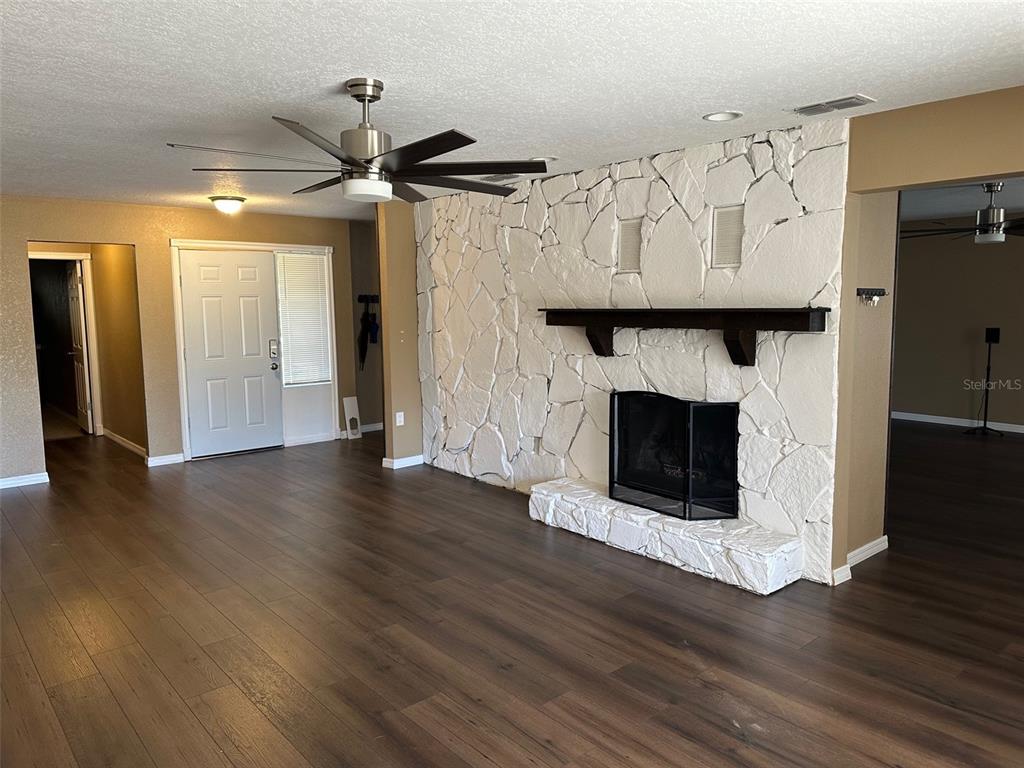 6848 Copperfield Drive New Port Richey, FL 34655 - Photo 12 of 20 a view of fireplace and wooden floor