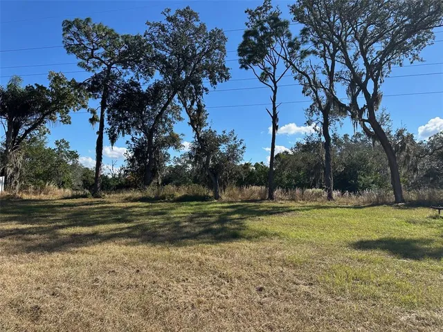 a view of a field with trees around