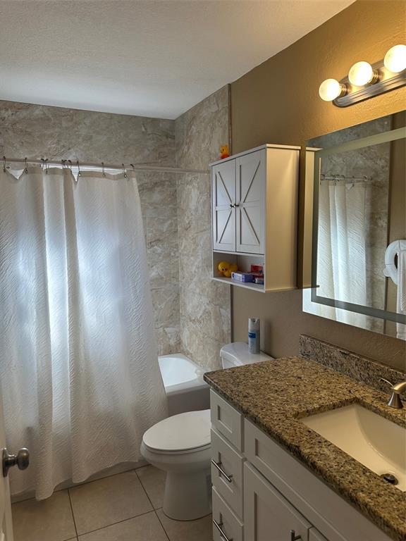 6848 Copperfield Drive New Port Richey, FL 34655 - Photo 5 of 20 a bathroom with a granite countertop sink toilet and shower