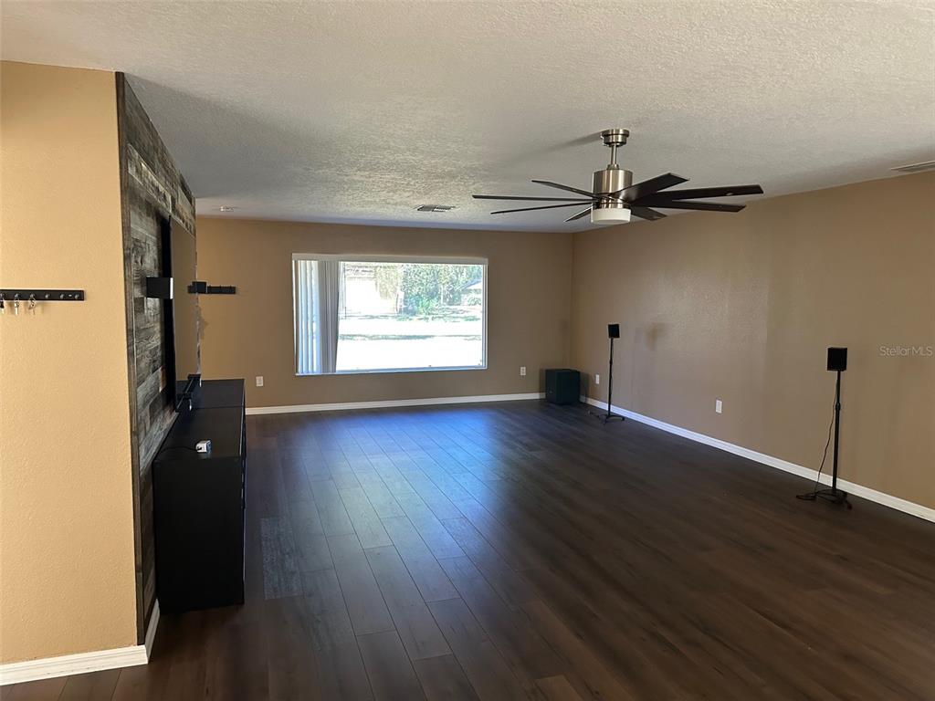 6848 Copperfield Drive New Port Richey, FL 34655 - Photo 7 of 20 an empty room with wooden floor closet and windows