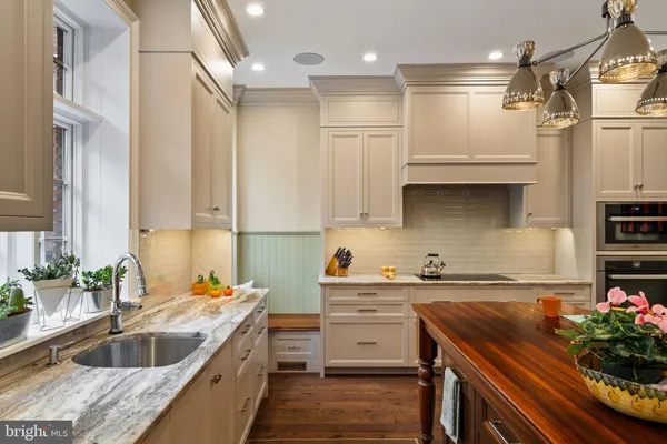 a kitchen with a sink stove and cabinets