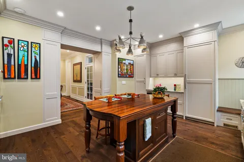 a kitchen that has a table and chairs in it