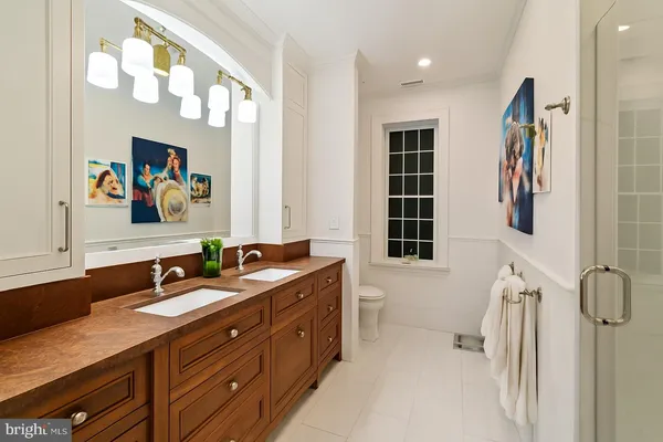 a bathroom with a sink double vanity and a mirror