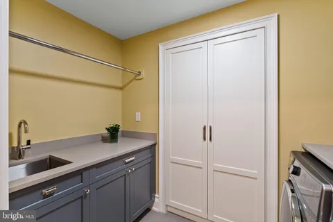 a living room with furniture a rug a lamp and a window