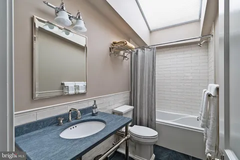 a view of staircase with wooden floor and white walls