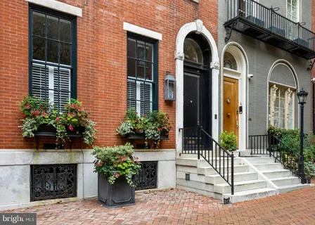 a black white and white photo of a living room