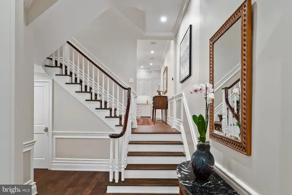 a view of entryway and hall with wooden floor