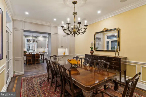 a view of a dining room with furniture and chandelier