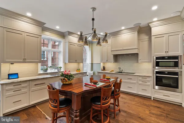 a kitchen with a table chairs stove and cabinets