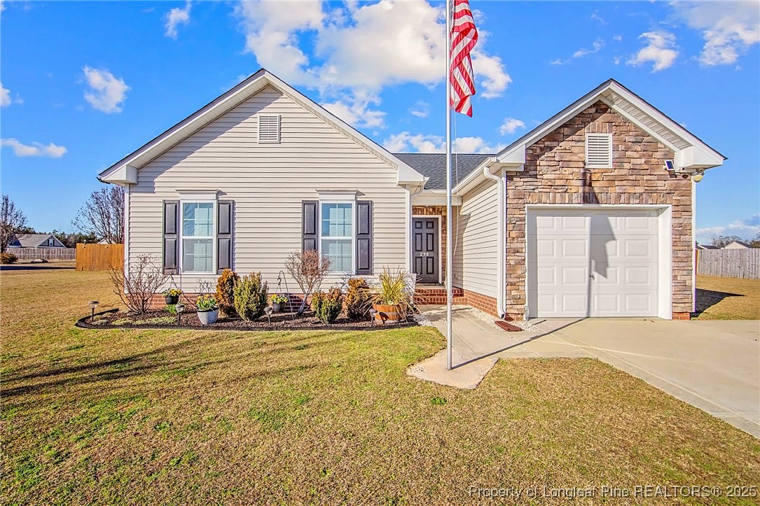 a front view of house with yard outdoor seating and garage