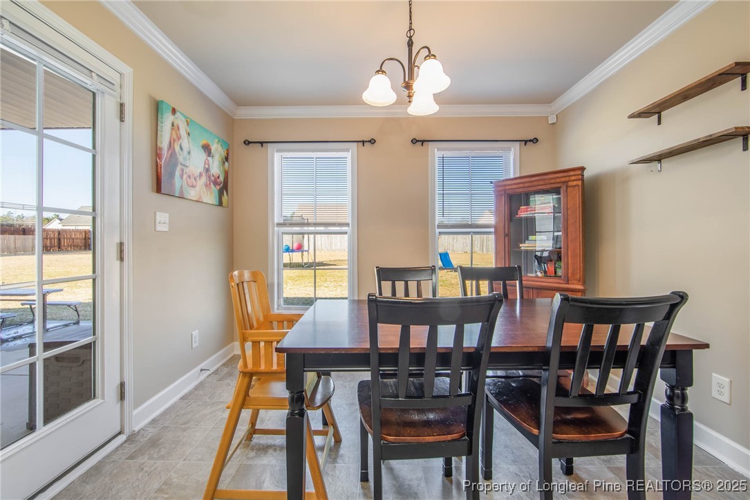 298 Declaration Drive Raeford, NC 28376 - Photo 11 of 31 a view of a dining room with furniture window and wooden floor