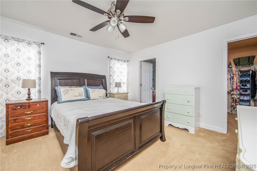 298 Declaration Drive Raeford, NC 28376 - Photo 15 of 31 a bedroom with a bed and a chandelier