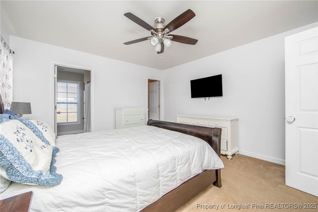 298 Declaration Drive Raeford, NC 28376 - Photo 16 of 31 a bedroom with a bed and a flat screen tv
