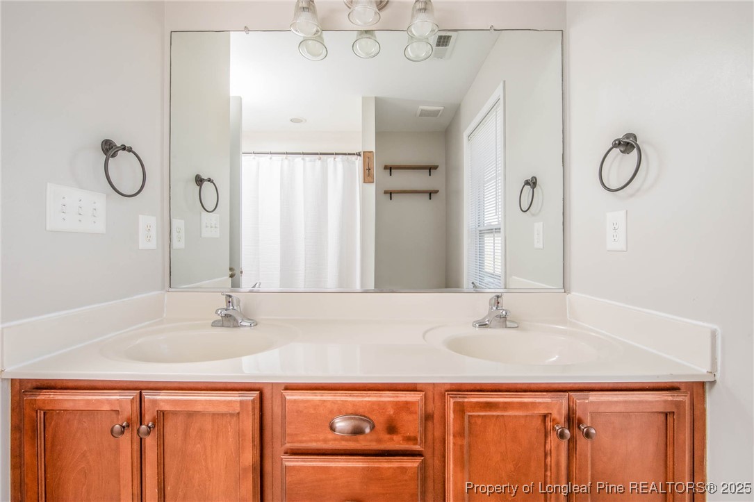 298 Declaration Drive Raeford, NC 28376 - Photo 18 of 31 a bathroom with a sink and a mirror