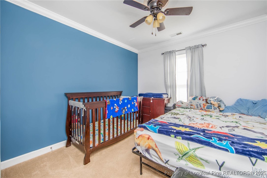 298 Declaration Drive Raeford, NC 28376 - Photo 20 of 31 a bedroom with a bed and a chandelier