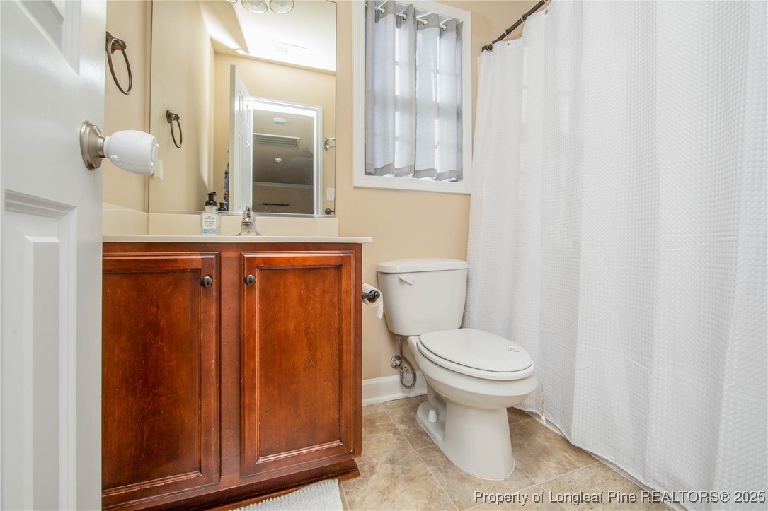 298 Declaration Drive Raeford, NC 28376 - Photo 23 of 31 a bathroom with a granite countertop toilet and a sink