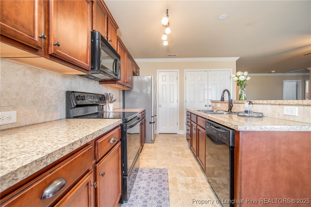 298 Declaration Drive Raeford, NC 28376 - Photo 8 of 31 a kitchen with stainless steel appliances granite countertop a sink and stove