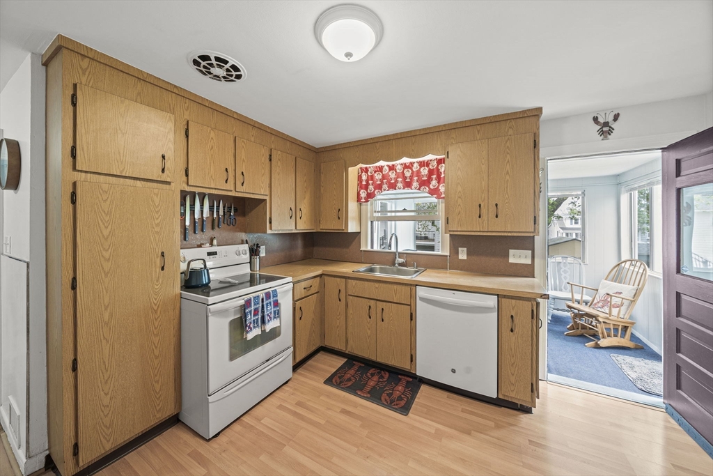 15 D Street Hull, MA 02045 - Photo 41 of 42 a kitchen with stainless steel appliances granite countertop a stove a sink and a refrigerator