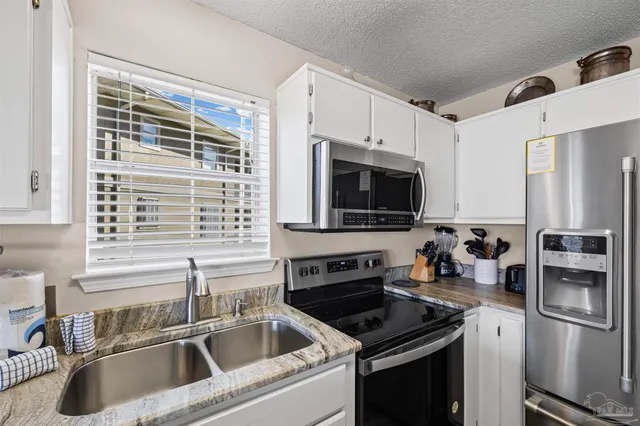 a view of a dining room with furniture a rug and wooden floor