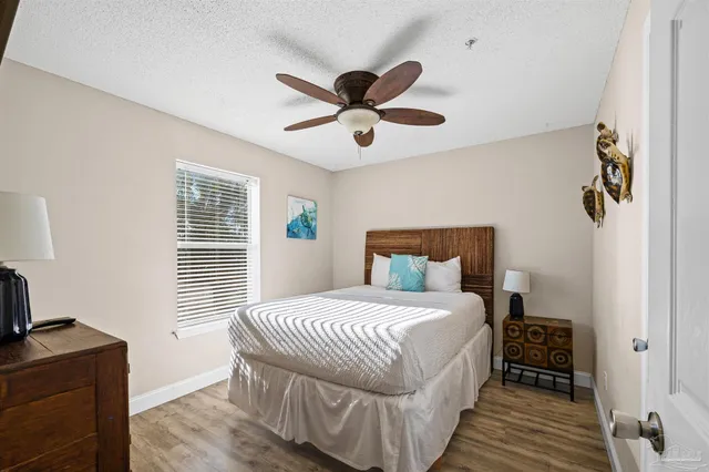 a bedroom with a bed and a flat tv screen on dresser