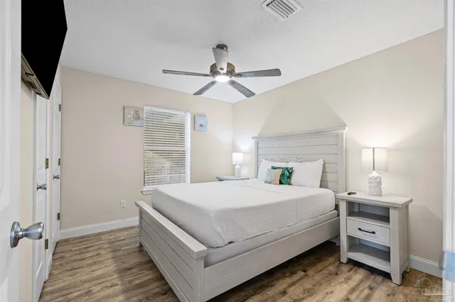 a bedroom with a large bed and a flat screen tv