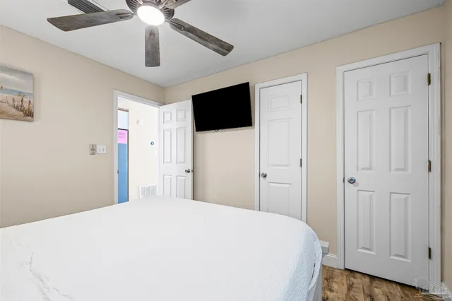 a bedroom with a bed and ceiling fan