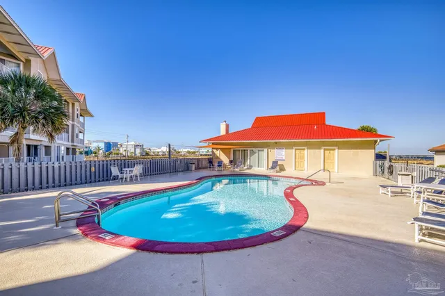 a view of a swimming pool with a lounge chair