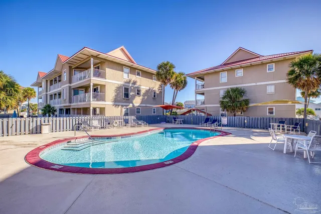 a view of a house with swimming pool and sitting area