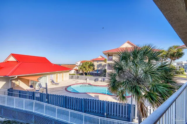 a view of a balcony with yard