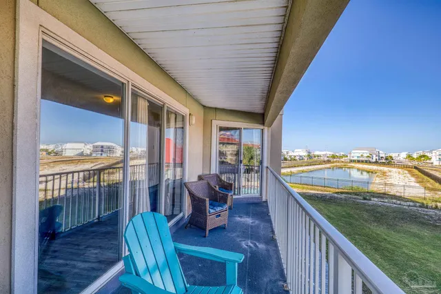 a view of a balcony with furniture and a floor to ceiling window