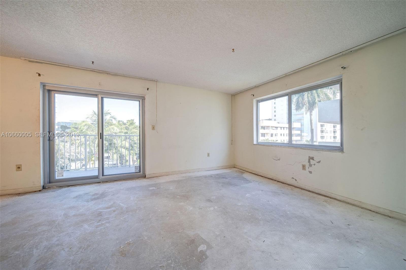 1674 Bay Road, Unit 403 Miami Beach, FL 33139 - Photo 11 of 23 an empty room with windows