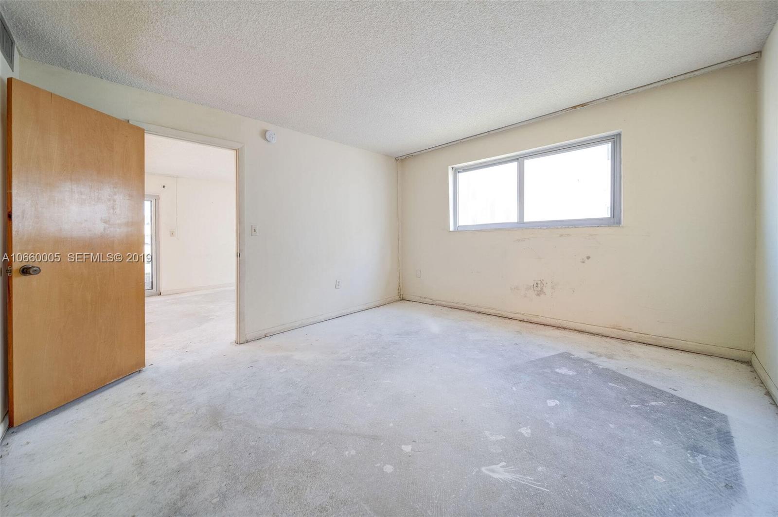 1674 Bay Road, Unit 403 Miami Beach, FL 33139 - Photo 12 of 23 an empty room with a empty space and windows