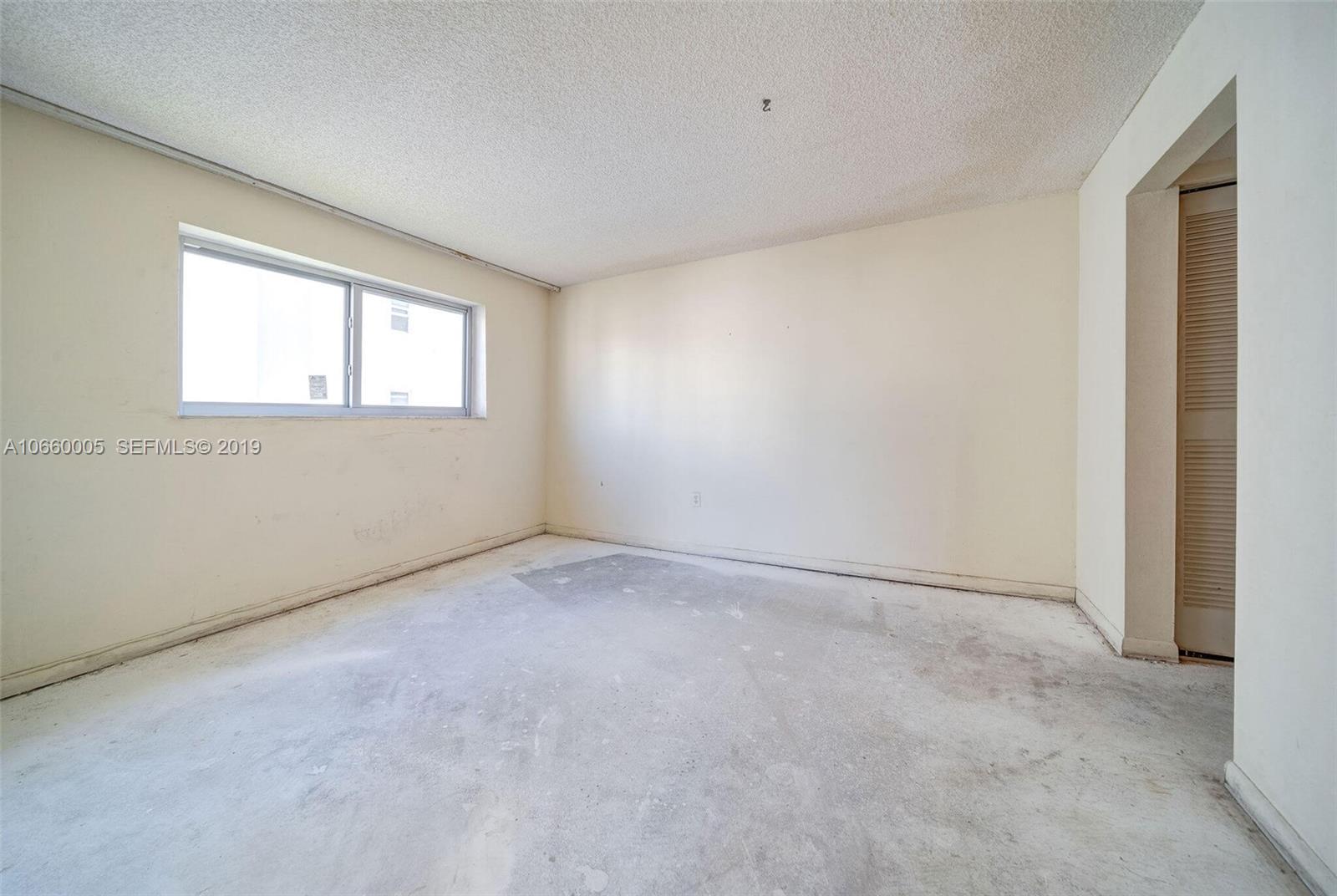 1674 Bay Road, Unit 403 Miami Beach, FL 33139 - Photo 13 of 23 an empty room with windows